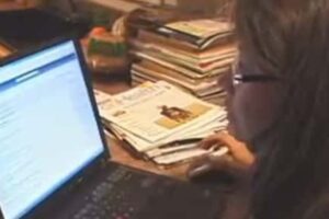 Woman looking at a computer screen, compiling the best resources for pet health